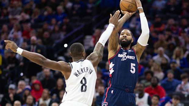 Feb 3, 2024; Philadelphia, Pennsylvania, USA; Philadelphia 76ers forward Marcus Morris Sr. (5) shoots the ball past Brooklyn Nets guard Lonnie Walker IV (8) during the first quarter at Wells Fargo Center.
